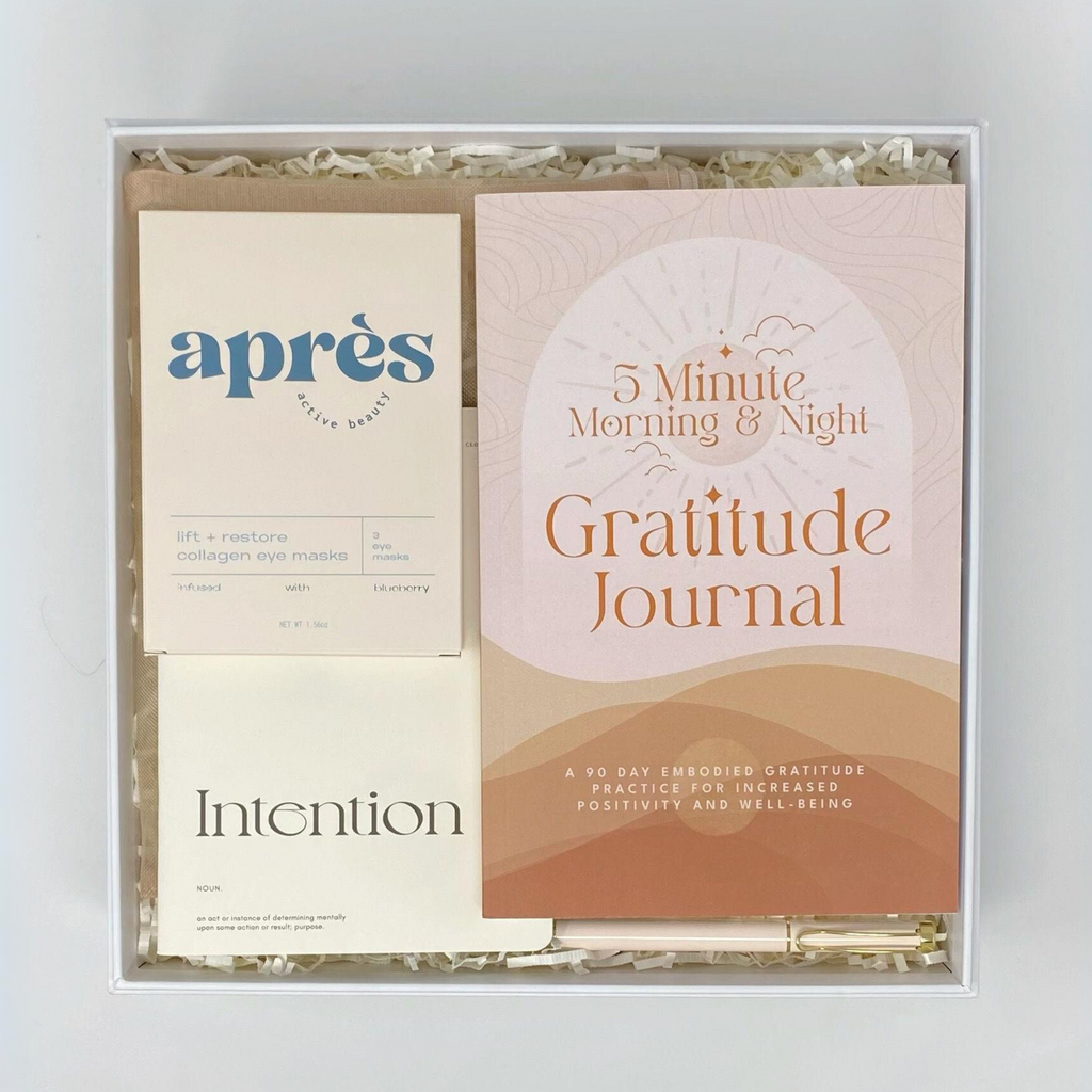 Sustainable and eco friendly gratitude gift box. Includes Aprés Active Beauty Collagen Eye Masks, Cloth & Paper Intention Mental Wellness Notebook, The Thought Canvas Gratitude Journal, and Sweet Water Decor Inspirational Pen. Presented in a reusable magnetic keepsake box crafted from recycled materials. 