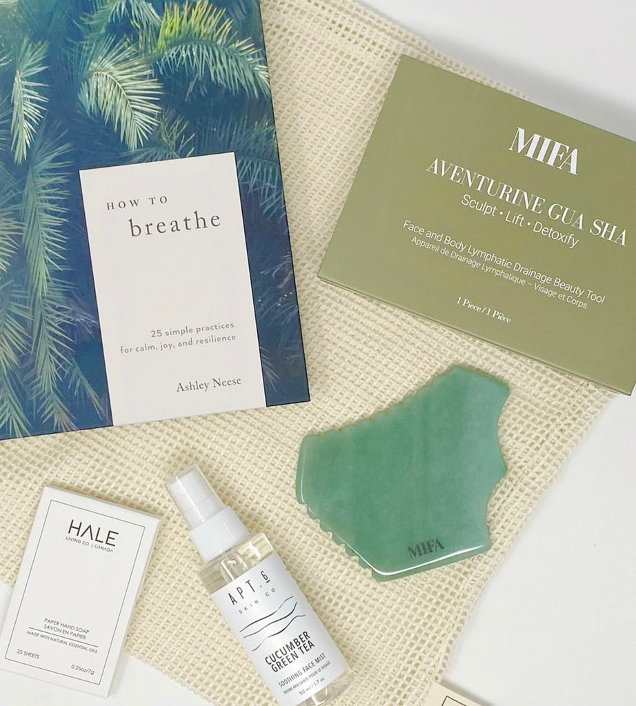 Green with envy gift box - contents how to breathe book, MIFA Gua Sha, Half Living Co Paper Hand Soap, Apt 6 cucumber green tea soothing face mist, the market bags large organic cotton produce bag