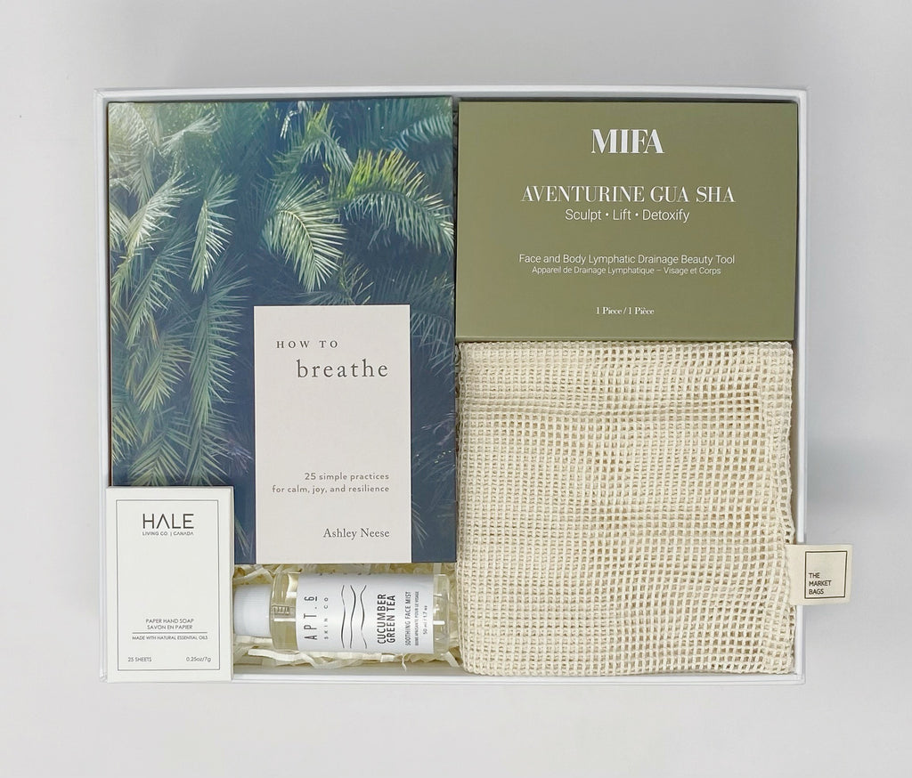 Green with envy gift box - contents how to breathe book, MIFA Gua Sha, Half Living Co Paper Hand Soap, Apt 6 cucumber green tea soothing face mist, the market bagslarge organic cotton produce bag