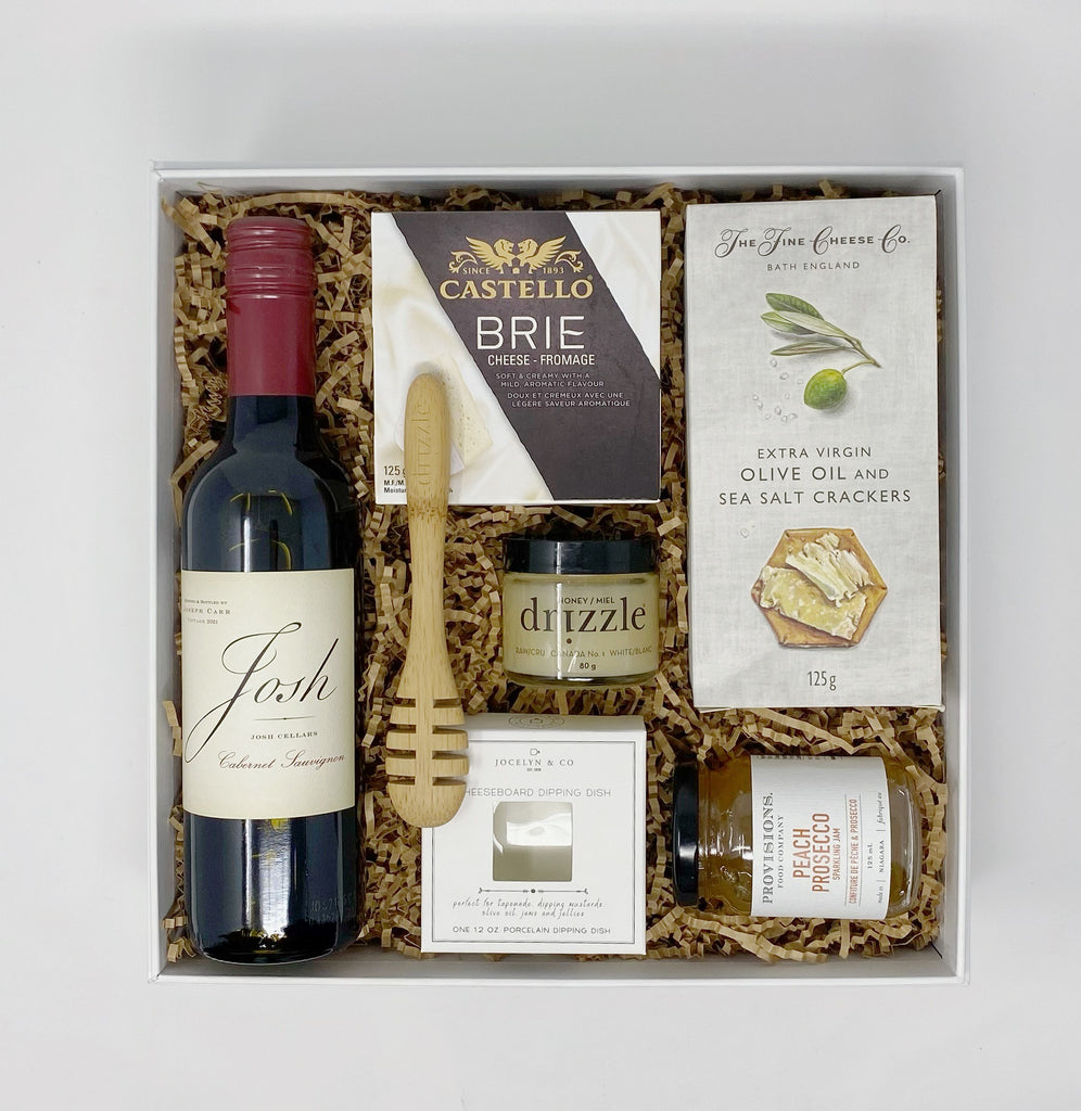 Mini Charcuterie Gift Box - Josh Cellars ~ Cabernet Sauvignon 375ml&nbsp;  The Fine Cheese Co ~ Fig, Honey &amp; Olive Oil Crackers  Provisions Food Company ~ Peach &amp; Prosecco Jam  Castello ~ Brie Cheese  Drizzle ~ Superfood Raw Organic Honey  Drizzle ~ Bamboo Honey Dipper  Jocelyn &amp; Co ~ Cheeseboard Dipping Dish
