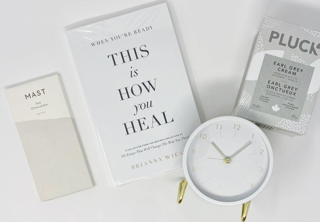 Take Time Gift Box contents - When You're Ready This is How You Will Heal book by Brianna Wiest, Pluck Earl Grey Cream Tea, Mast Tea Chocolate Bar & The Decent Living - Desk Clock - White & Gold